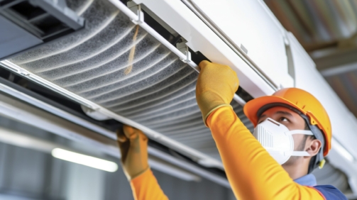 Technician checking and changing the filters of a domestic air conditioning split. AI generated.